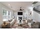 Inviting living room with fireplace, built-ins, comfortable seating, and natural light at 1909 Summey Ave, Charlotte, NC 28205