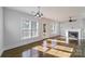 Bright, airy living area boasts hardwood floors, large windows, and a cozy fireplace at 1909 Summey Ave, Charlotte, NC 28205