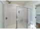 Close-up of shower with frameless glass doors, rain shower head, and built-in bench at 1909 Summey Ave, Charlotte, NC 28205