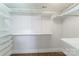 Custom walk-in closet with multiple levels of white shelving for maximum storage and organization at 1909 Summey Ave, Charlotte, NC 28205