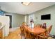 Dining area featuring a wood table with six chairs, open to the kitchen, and a television on the wall at 195 Kings Ter, Salisbury, NC 28146