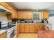 Functional kitchen featuring wood cabinets, laminate countertops, and essential appliances including an oven and dishwasher at 195 Kings Ter, Salisbury, NC 28146