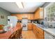 Spacious kitchen with wood cabinets, laminate countertops, and white appliances, adjacent to a dining table at 195 Kings Ter, Salisbury, NC 28146