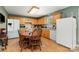 Well-equipped kitchen featuring wood cabinets, a dining table, and a combination of black and white appliances at 195 Kings Ter, Salisbury, NC 28146