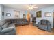 Bright and airy living room featuring a sectional sofa, a recliner, and light wood flooring at 195 Kings Ter, Salisbury, NC 28146