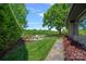 Backyard featuring an outdoor seating area overlooking the lake and lush greenery at 19501 River Falls Dr, Davidson, NC 28036