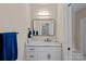 Well-lit bathroom with white vanity, marble countertop, and modern fixtures, providing a fresh, clean aesthetic at 19501 River Falls Dr, Davidson, NC 28036