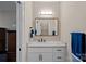Bright bathroom featuring a marble countertop, white vanity, and modern fixtures with a well-lit space at 19501 River Falls Dr, Davidson, NC 28036