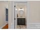 Elegant powder room featuring a marble countertop, dark wood vanity, and stylish fixtures at 19501 River Falls Dr, Davidson, NC 28036