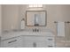 Elegant bathroom features a marble countertop, white cabinetry, and modern fixtures at 19501 River Falls Dr, Davidson, NC 28036