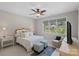 Inviting bedroom with a large window, ceiling fan, and cozy seating area, offering a relaxing space at 19501 River Falls Dr, Davidson, NC 28036