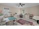 Bright bonus room featuring custom desk, ceiling fan and neutral decor at 19501 River Falls Dr, Davidson, NC 28036