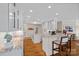 Open kitchen with white cabinets, granite countertops, a kitchen island, and hardwood flooring at 19501 River Falls Dr, Davidson, NC 28036