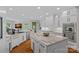 Modern kitchen with white cabinets, granite countertops, stainless steel appliances, and hardwood floors at 19501 River Falls Dr, Davidson, NC 28036