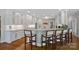 Bright kitchen features white cabinets, granite countertops, stainless steel appliances, and hardwood floors at 19501 River Falls Dr, Davidson, NC 28036