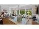 Cozy living room with hardwood floors, large windows, comfortable seating, and natural light at 19501 River Falls Dr, Davidson, NC 28036