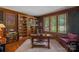 Well-appointed home office with custom built-in bookshelves and natural light at 19501 River Falls Dr, Davidson, NC 28036