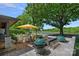 Outdoor grilling area with a ceramic cooker, stainless grill and serene golf course views at 19501 River Falls Dr, Davidson, NC 28036