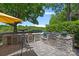 Outdoor kitchen featuring a built-in grill, bar seating, and scenic lake views at 19501 River Falls Dr, Davidson, NC 28036