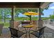 Inviting covered outdoor living space overlooking a lush green golf course and pond at 19501 River Falls Dr, Davidson, NC 28036
