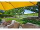 Relaxing outdoor view featuring a beautiful golf course, pond, and patio seating area at 19501 River Falls Dr, Davidson, NC 28036