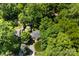 Stunning aerial view of a house surrounded by mature trees and lush greenery in a peaceful setting at 2008 Highland St, Charlotte, NC 28208