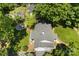 Aerial view of a house with lush trees, featuring a backyard with a fire pit and well-maintained landscaping at 2008 Highland St, Charlotte, NC 28208