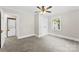 Bedroom with neutral walls, plush carpet, ceiling fan, closet, and laundry in the adjacent room at 2008 Highland St, Charlotte, NC 28208