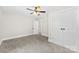 Spacious bedroom featuring neutral walls, plush carpet, ceiling fan, and ample closet space at 2008 Highland St, Charlotte, NC 28208