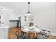 Open dining area with a round table, contemporary chairs, and a view into the modern kitchen at 2008 Highland St, Charlotte, NC 28208
