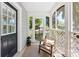 Charming front porch with wicker chair, neutral rug, and views of the neighborhood at 2008 Highland St, Charlotte, NC 28208