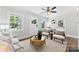 Inviting living room featuring hardwood floors, a comfortable sofa, and abundant natural light from the windows at 2008 Highland St, Charlotte, NC 28208