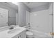 Clean bathroom features a shower and bath, with white tiles and grey-blue walls at 2025 Groves Edge Ln, Waxhaw, NC 28173