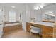 Bright bathroom with double vanity, a soaking tub, and natural light at 2025 Groves Edge Ln, Waxhaw, NC 28173