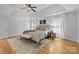 Spacious main bedroom with tray ceilings, ceiling fan, hardwood floors, and cozy decor at 2025 Groves Edge Ln, Waxhaw, NC 28173