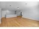 Large, open bonus room provides versatile space with neutral walls and hardwood flooring at 2025 Groves Edge Ln, Waxhaw, NC 28173