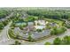 A high angle view of a community's swimming pool, tennis courts, and clubhouse at 2025 Groves Edge Ln, Waxhaw, NC 28173