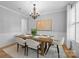 Elegant dining room featuring a wooden table with seating and a chandelier at 2025 Groves Edge Ln, Waxhaw, NC 28173
