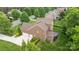 Brick home featuring an attached two-car garage, back deck, and manicured lawn at 2025 Groves Edge Ln, Waxhaw, NC 28173