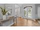 Inviting foyer with wood flooring, a console table, and a view of the entryway at 2025 Groves Edge Ln, Waxhaw, NC 28173