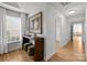 Stylish hallway with hardwood floors, decorative console table, and open doorway at 2025 Groves Edge Ln, Waxhaw, NC 28173