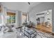 Inviting living room with vaulted ceilings, natural light, comfortable seating, and clear view to a modern kitchen at 2025 Groves Edge Ln, Waxhaw, NC 28173