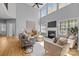 Bright living room with high ceilings, a fireplace, large windows, and comfortable furnishings at 2025 Groves Edge Ln, Waxhaw, NC 28173