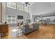 Open-concept living room flows into kitchen featuring hardwood floors, a fireplace and generous natural light at 2025 Groves Edge Ln, Waxhaw, NC 28173