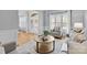 Bright living room with a round coffee table, neutral furniture, and large windows at 2025 Groves Edge Ln, Waxhaw, NC 28173