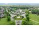 Aerial view of a neighborhood featuring a roundabout with manicured landscaping and a community pool at 2025 Groves Edge Ln, Waxhaw, NC 28173