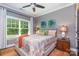 Comfortable bedroom with a queen-size bed, neutral colors, and a bright window at 219 Reese Wilson Rd, Belmont, NC 28012