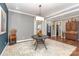 Formal dining room with elegant lighting, table, and hardwood floors at 219 Reese Wilson Rd, Belmont, NC 28012
