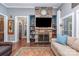 Cozy living room with stone fireplace, built-in shelves, and comfortable seating and hardwood floors at 219 Reese Wilson Rd, Belmont, NC 28012