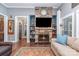 Cozy living room with stone fireplace, built-in shelves, and comfortable seating and hardwood floors at 219 Reese Wilson Rd, Belmont, NC 28012